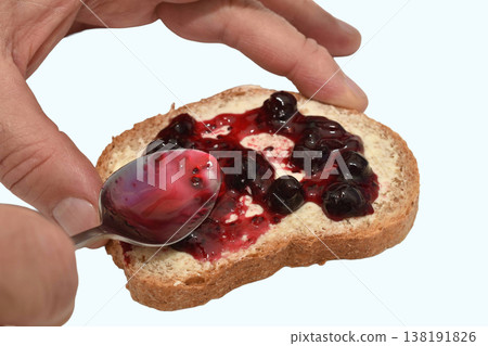 A slice of bread with butter and berry jam A slice of bread with butter and berry jam 138191826
