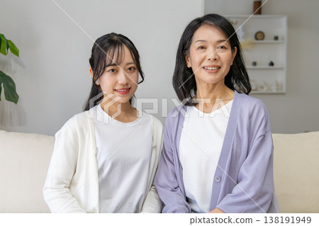 A close mother and daughter huddled together. 138191949