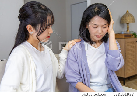 A mother who is unwell and her worried daughter A mother who is unwell and her worried daughter 138191958
