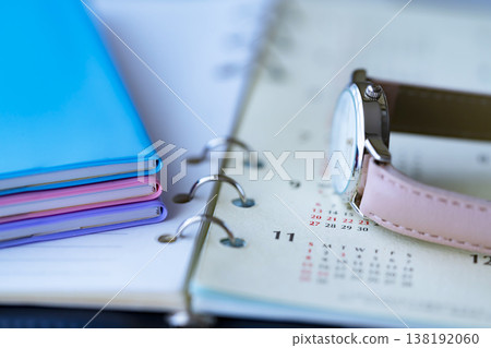 A calendar, a notebook and a watch on the table A calendar, a notebook and a watch on the table 138192060