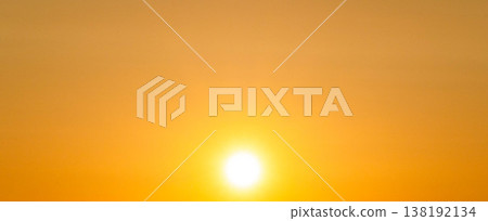 The clear sky glows golden as a beautiful sunset sinks into the western sky. The clear sky glows golden as a beautiful sunset sinks into the western sky. 138192134