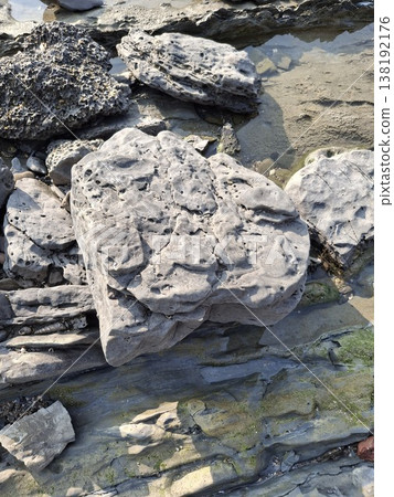 Weathered Coastal Rocks And Tide Pool Texture On A Rocky Shoreline In Soft Light 138192176