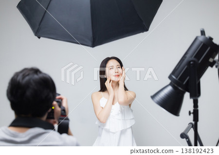 Woman watching camera Woman watching camera 138192423