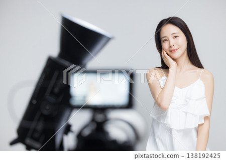 Woman watching camera 138192425