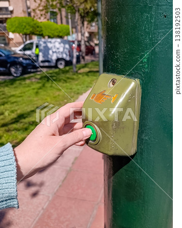 Female Hand Pressing Pedestrian Crossing Button 138192503
