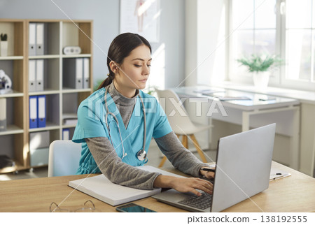 Focused Female Doctor Researching Online In Clinic 138192555