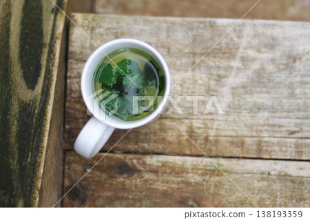 Cup Of Fresh Herbal Tea On Wooden Steps  138193359