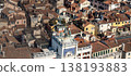 Historic bell tower rising above Venetian rooftops 138193883