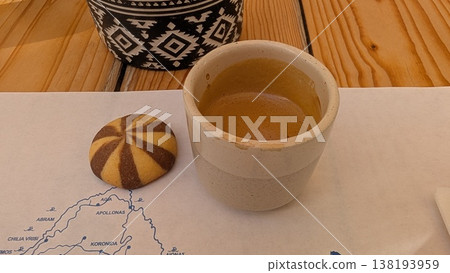 A cookie with coffee in a small ceramic cup 138193959