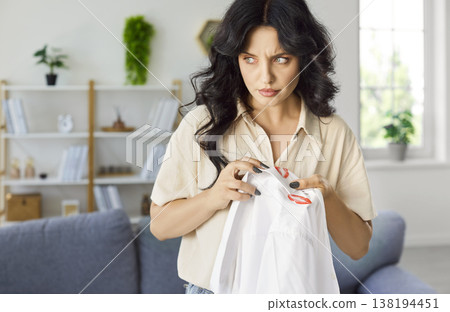 Jealous wife holding shirt of husband with cheating and adultery evidences at home Jealous wife holding shirt of husband with cheating and adultery evidences at home 138194451