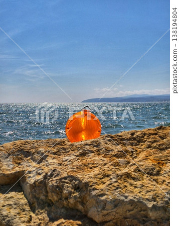 Orange safety reflector on a rocky sea pier, Sea coast. 138194804