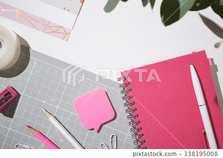 Pink workspace flat lay with notebook and clips for creative planning on white background. Copyspace. Pink workspace flat lay with notebook and clips for creative planning on white background. Copyspace. 138195008