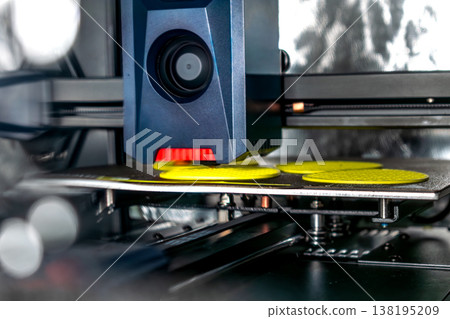 3d printer printing an object on the tray with filament 138195209
