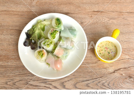 steamed Thai large rice noodles salad roll stuffed shrimp and salmon couple tuna on plate dipping spicy chili cheese sauce steamed Thai large rice noodles salad roll stuffed shrimp and salmon couple tuna on plate dipping spicy chili cheese sauce 138195781