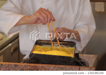 A scene of a craftsman making rolled omelet. A scene of a craftsman making rolled omelet. 138196149