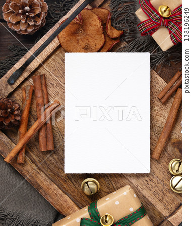 Vertical blank card on rustic wooden tray near Christmas decor top view. Holiday mockup Vertical blank card on rustic wooden tray near Christmas decor top view. Holiday mockup 138196249