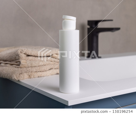 White blank flip top cosmetic bottle near bath towel in beige bathroom, cosmetic mockup White blank flip top cosmetic bottle near bath towel in beige bathroom, cosmetic mockup 138196254