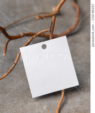 Blank square gift tag mockup on grey stone with dry branches, copy space. Handmade product label Blank square gift tag mockup on grey stone with dry branches, copy space. Handmade product label 138196267
