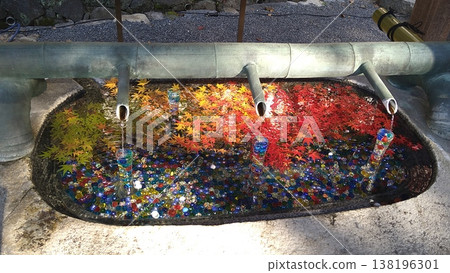 The water basin at Okadera Temple, adorned with marbles and autumn leaves. The water basin at Okadera Temple, adorned with marbles and autumn leaves. 138196301