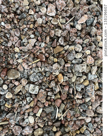 Pebbles and stones mixed together on the ground in an outdoor setting 138196607