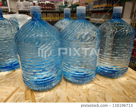 Bottles of blue water on display at a store in the afternoon sun Bottles of blue water on display at a store in the afternoon sun 138196713
