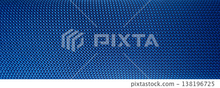 Textured blue fabric close-up showing woven pattern in soft light Textured blue fabric close-up showing woven pattern in soft light 138196725