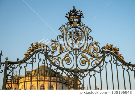 Stupinigi, turin, italy. March 23, 2026. Stupinigi hunting lodge ornate wrought iron gate featuring a royal crown and coat of arms under a clear blue sky Stupinigi, turin, italy. March 23, 2026. Stupinigi hunting lodge ornate wrought iron gate featuring a royal crown and coat of arms under a clear blue sky 138196948