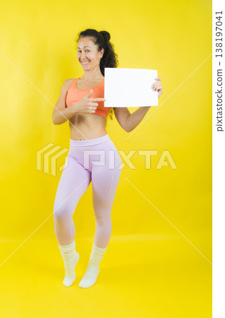 Smiling woman pointing at blank white board for message 138197041