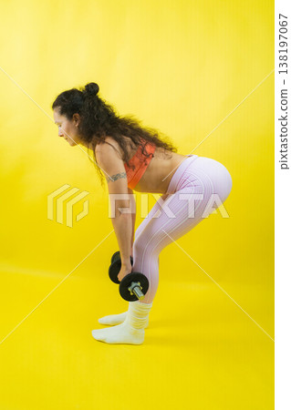Woman exercising with dumbbells for fitness and workout Woman exercising with dumbbells for fitness and workout 138197067
