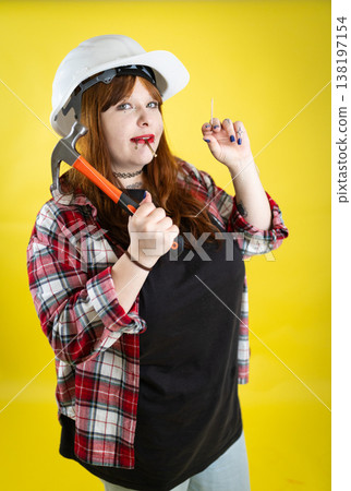 Confident woman builder holding tools ready for diy work Confident woman builder holding tools ready for diy work 138197154