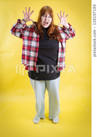 Young woman making funny monster face, acting playful 138197189