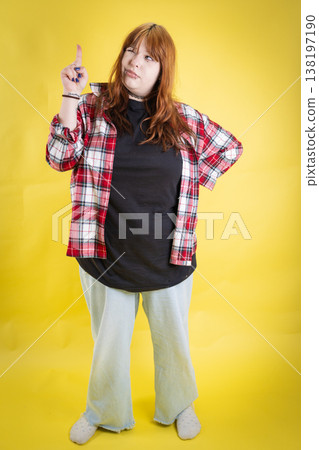 Young woman thinking, pointing up, having new idea 138197190