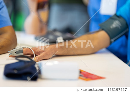Patient receiving health checkup measuring oxygen and blood pressure 138197337