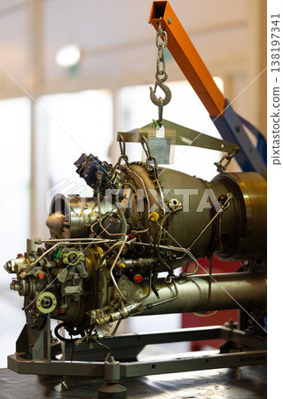 Jet engine undergoing maintenance, repair, and overhaul in workshop Jet engine undergoing maintenance, repair, and overhaul in workshop 138197341