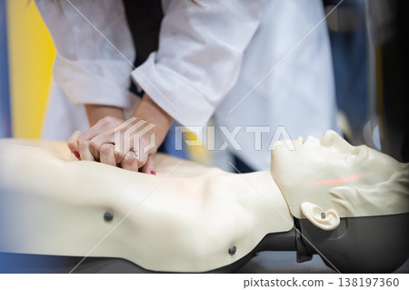 Person performing cardiopulmonary resuscitation on training dummy Person performing cardiopulmonary resuscitation on training dummy 138197360