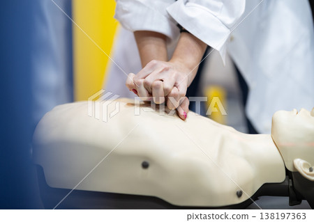 Student hands performing cpr on medical training dummy Student hands performing cpr on medical training dummy 138197363