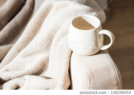 Cozy Sofa with Blanket and Coffee Mug. Relaxed Home Atmosphere Cozy Sofa with Blanket and Coffee Mug. Relaxed Home Atmosphere 138200059