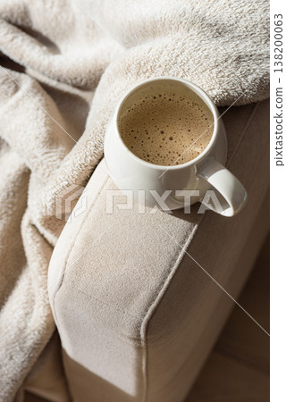 Cozy Sofa with Blanket and Coffee Mug. Relaxed Home Atmosphere 138200063