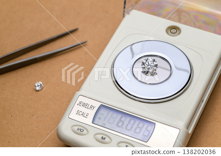 Close-up: gemstone on scale with digital readout Close-up: gemstone on scale with digital readout 138202036