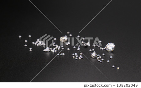 Dark background highlights sparkling gemstones of various sizes Dark background highlights sparkling gemstones of various sizes 138202049