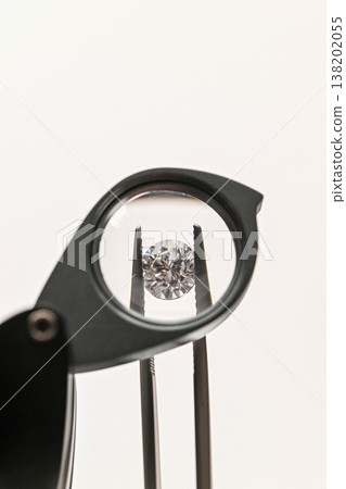 Close-up of diamond being examined with magnifying tool Close-up of diamond being examined with magnifying tool 138202055
