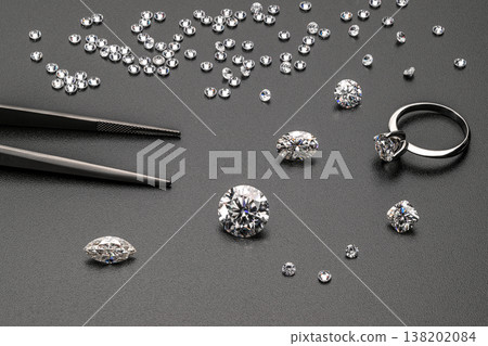 Close-up of loose diamonds and tools for setting Close-up of loose diamonds and tools for setting 138202084