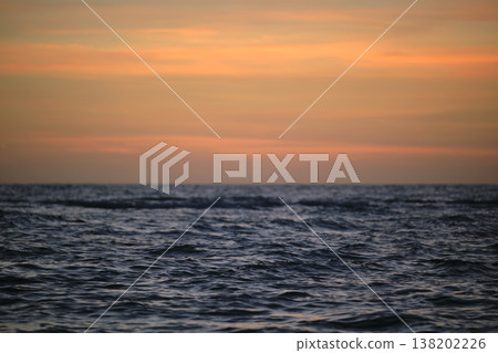 Dramatic red ocean waves at sunset with soft evening sea dark water Dramatic red ocean waves at sunset with soft evening sea dark water 138202226