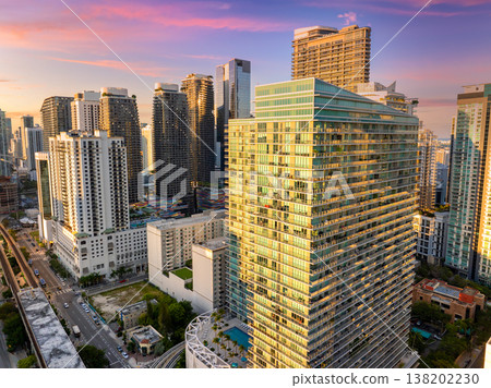 Downtown district of Miami Brickell in Florida, USA at sunset. Urban landscape of high-rise buildings in modern American megapolis Downtown district of Miami Brickell in Florida, USA at sunset. Urban landscape of high-rise buildings in modern American megapolis 138202230