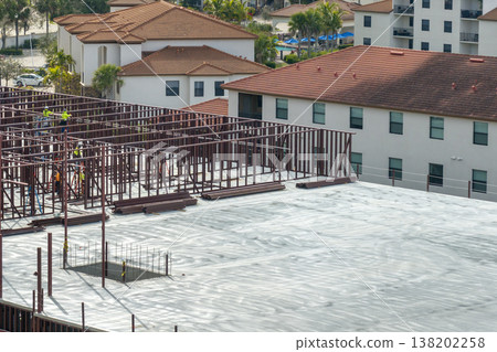 Construction site with many workers and equipment in Fort Myers, Florida. Hard labor employment at commercial development Construction site with many workers and equipment in Fort Myers, Florida. Hard labor employment at commercial development 138202258