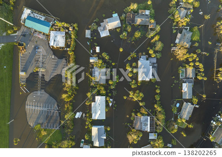 Consequences of natural disaster. Heavy flood with high water surrounding residential houses after hurricane Ian rainfall in Florida residential area Consequences of natural disaster. Heavy flood with high water surrounding residential houses after hurricane Ian rainfall in Florida residential area 138202265