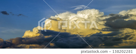 Colorful sunset sky with setting sun behind vivid orange and yellow clouds Colorful sunset sky with setting sun behind vivid orange and yellow clouds 138202281