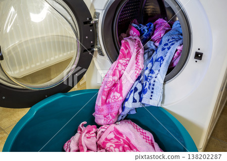 Colorful clothes and towels in washing machine drum 138202287