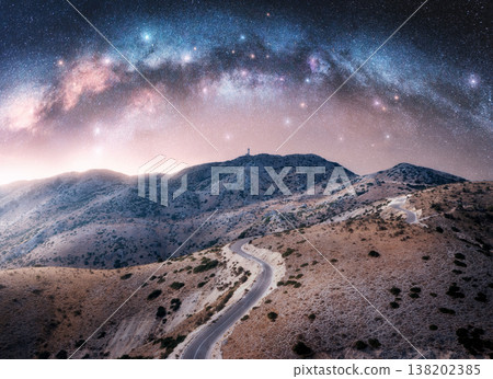 Milky Way arch and winding mountain road at night Milky Way arch and winding mountain road at night 138202385