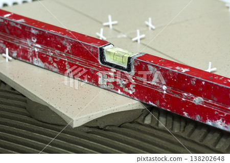 Ceramic tiles and tools for tiler. Floor tiles installation. Home improvement, renovation - ceramic tile floor adhesive Ceramic tiles and tools for tiler. Floor tiles installation. Home improvement, renovation - ceramic tile floor adhesive 138202648